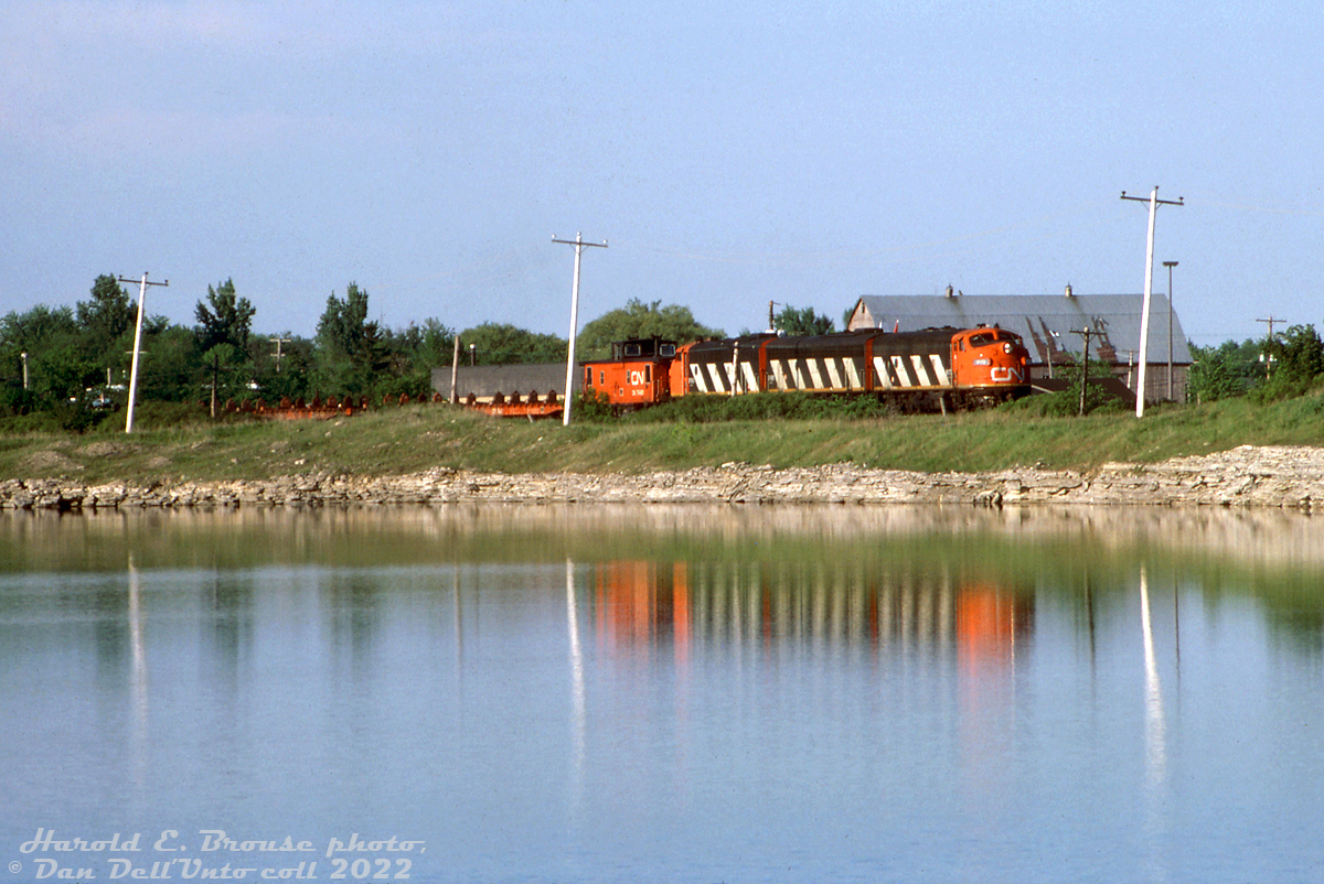 During the brief period in time when solid A-B-A sets of zebra-striped F-units were the order of the day on the Steel Train, CN 9173, 9195 and 9166 handle train #725, rolling past a pond just south of Hagersville on the Hagersville Sub. 

Harold E. Brouse photo, Dan Dell'Unto collection slide.