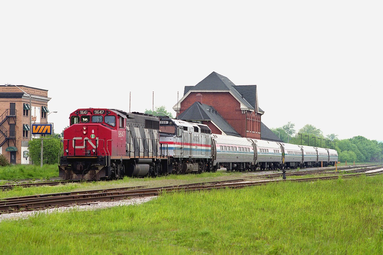 On this day AMTK #97's unit #258 suffered ground relay problems. So, CN 9647 brought it down to Niagara Falls station.  Didn't hang around to see if Conrail came over to take it into the States because I had to get ready to go to work in an hour.
Dull weather gave me the opportunity to shoot this on what would have normally been the "wrong side" if the sun had been out.  I'm using 120 Fuji Velvia print film, which gives strong green, and it helps the image on grayish days. Mamiya 645E medium format.