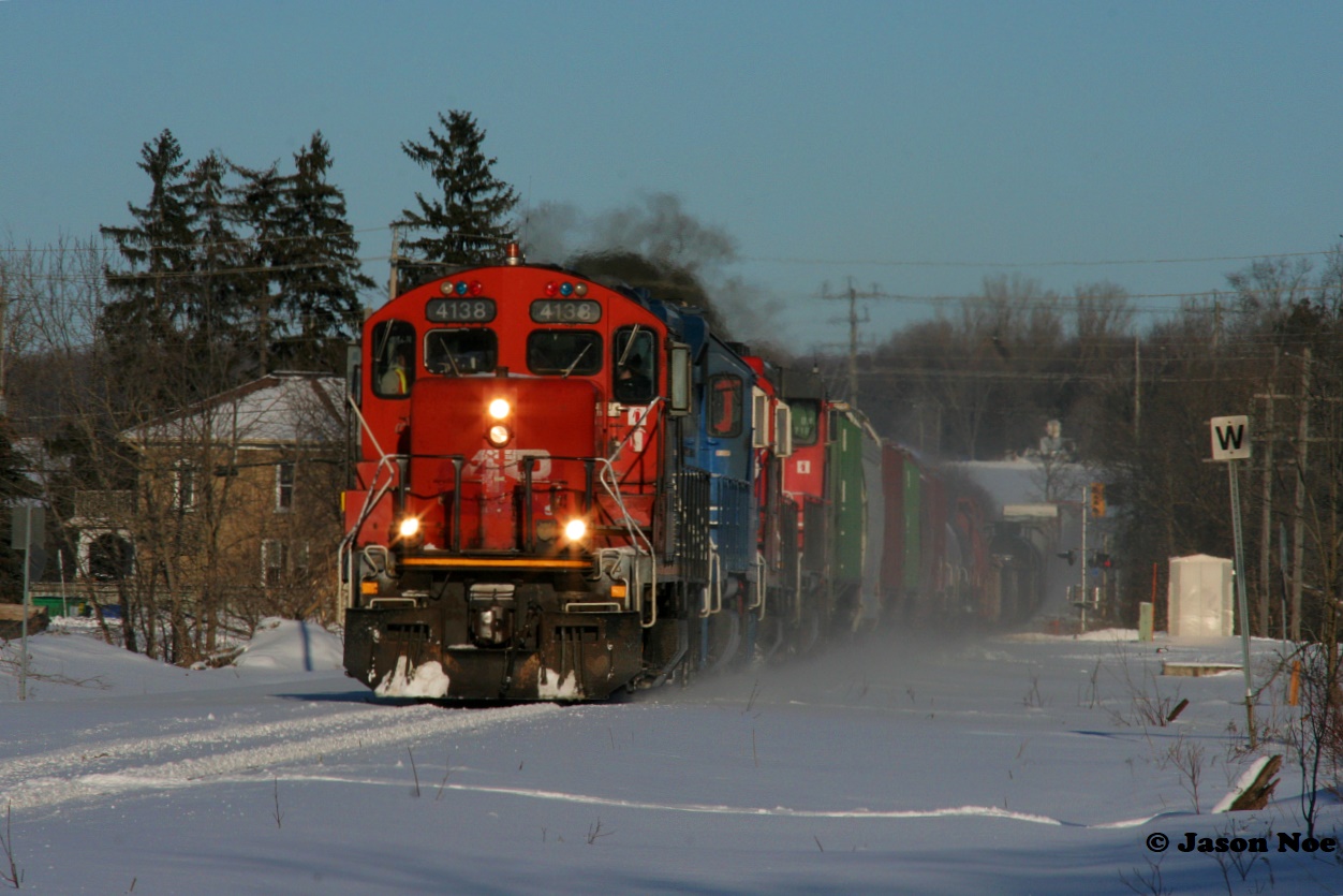One year ago exactly, CN 4138 is viewed leading L568 through Baden, Ontario during a perfect winter afternoon heading west on the Guelph Subdivision.  One year later, and CN 4138 is once again assigned to Kitchener and has been observed leading L568 making scenes such as this possible, although the sun hasn’t been as co-operative as in 2022.