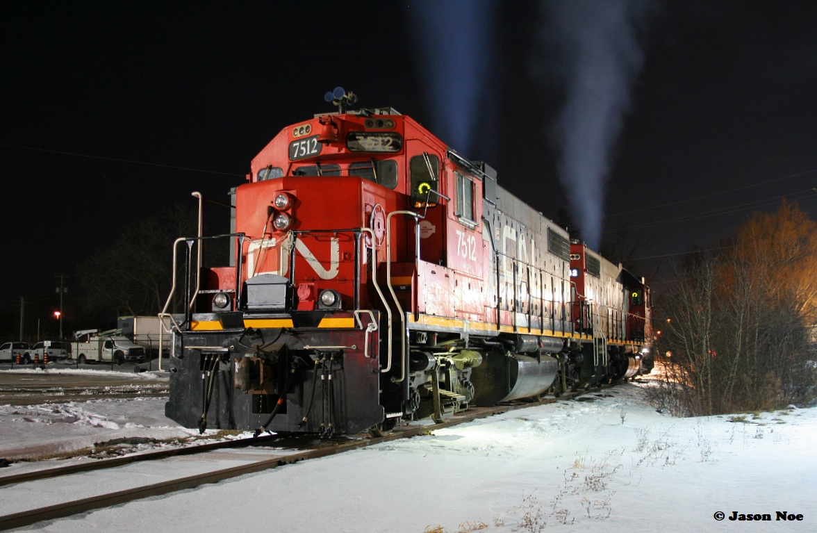 This night was so cold. Oh man, I get cold even thinking about it. 

However an ex-CN hump yard assigned GP38-2 in Cambridge, Ontario now operating on CN L542 did require a bit of attention. So a short drive from Kitchener and some minor possible frostbite was worth the effort. Here, CN 7512 and 4732 are slumbering away during a quiet Friday evening at the former CN outpost along Eagle Street in Cambridge on the Fergus Spur.