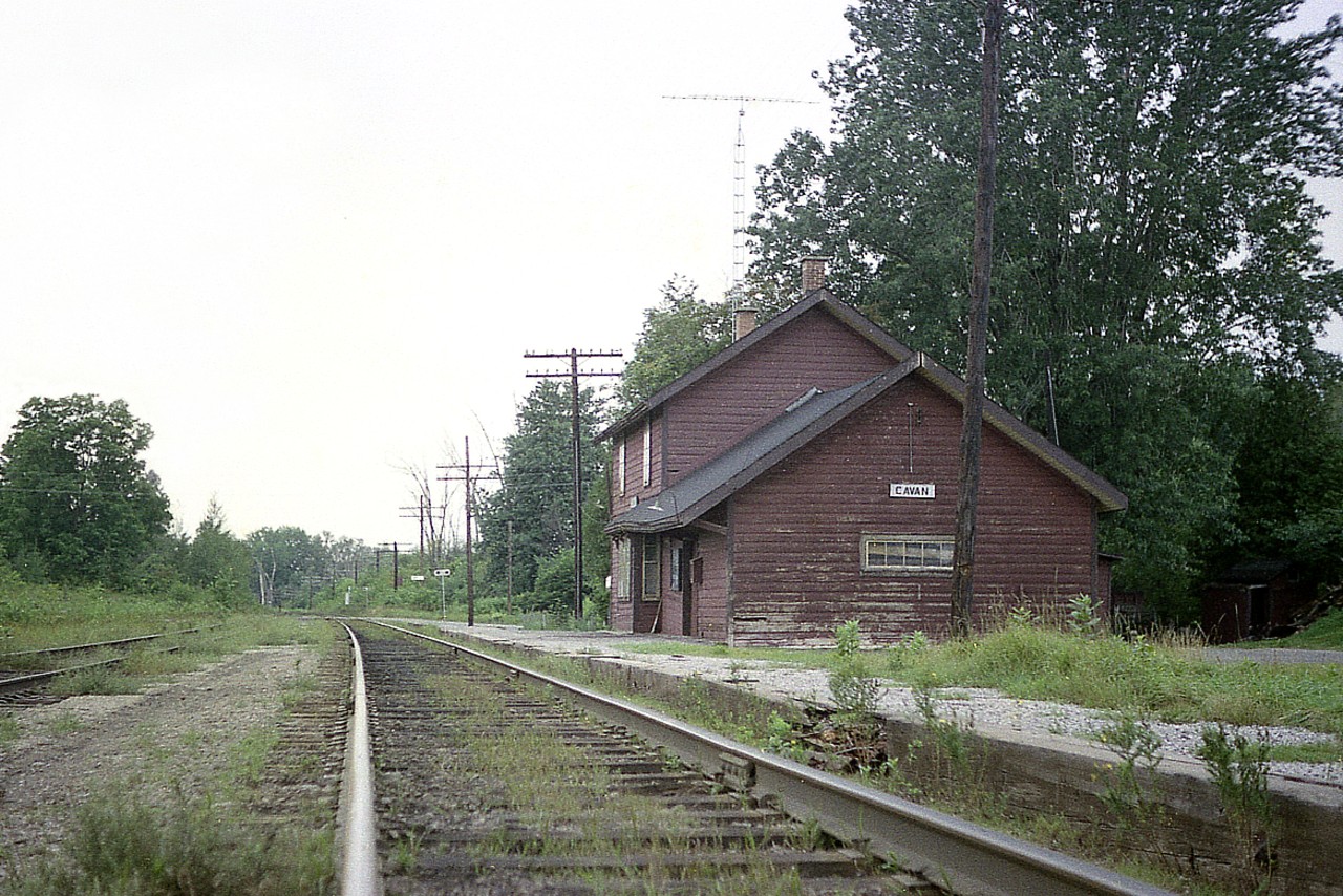 A view looking west along the CP Havelock sub featuring the old Cavan station. This community was located about 10 miles west of Peterborough.  The station is in rough shape, and not long after this photo was taken it was torn down.  I do not have the exact date but no doubt it met its demise when CP did some "housekeeping" along the line in the latter half of the 1970s.
Today this track is part of a CP "Internal Short line", the Kawartha Lakes Railway.