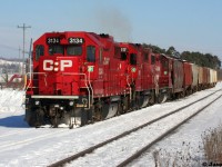 An Extra CP Wolverton Job with 3134, 3117 and 3045 is viewed with its train together ready to pull ahead and then shove down the Ayr Pit Spur in Ayr, Ontario during a beautiful winter afternoon.