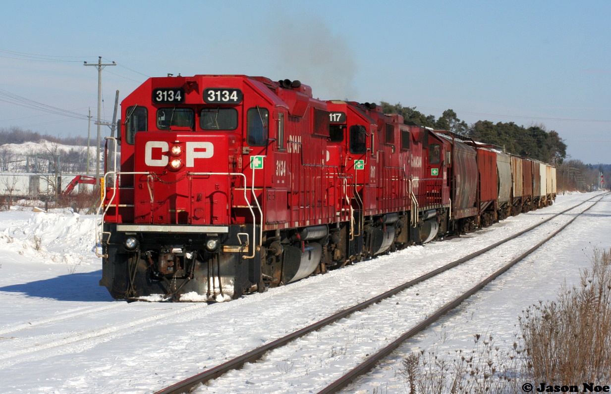 An Extra CP Wolverton Job with 3134, 3117 and 3045 is viewed with its train together ready to pull ahead and then shove down the Ayr Pit Spur in Ayr, Ontario during a beautiful winter afternoon.