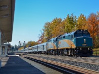 VIA #1 "The Canadian" crawls past the platform at Bloomington GO on a sunny October morning as the vibrant fall colours in the background begin to fall. Unseen in this image is the empty coach tacked on to the timeless Park car at the end of the train, a new practice for VIA after Transport Canada deemed their Budd coaches "not structurally sound".