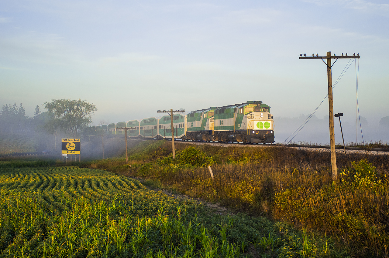 GO 3710 behind its usual pair of GMD F59PHs cuts through the morning fog approaching New Hamburg.