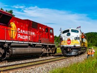 CP sent their business train east to Thunder Bay and Schreiber in 2010 to host a week of excursions over the Nipigon and Heron Bay Subs in celebration of their 150th anniversary. Here we capture a special moment as the crew along with a retired CP engineer watch CP 9113 West with train 223-13 take the siding at the east end of Coldwell on the Heron Bay Sub. Once 223 clears the power of the locally dubbed "Superior Flyer" will run around their train, couple up and return to Schreiber.