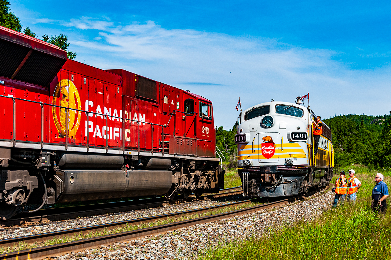 CP sent their business train east to Thunder Bay and Schreiber in 2010 to host a week of excursions over the Nipigon and Heron Bay Subs in celebration of their 150th anniversary. Here we capture a special moment as the crew along with a retired CP engineer watch CP 9113 West with train 223-13 take the siding at the east end of Coldwell on the Heron Bay Sub. Once 223 clears the power of the locally dubbed "Superior Flyer" will run around their train, couple up and return to Schreiber.