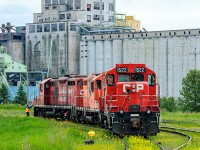 The crew of the afternoon Current River job pauses inside the gate of Viterra "C House" (still called "ugga" by crews referring to United Grain Growers A House) before gathering up tracks of grain empties with CP 1522-1640-1574. In the background the abandoned and decrepit Pool 4A and 4B complex, while behind that the yellow top of JRI's massive grain terminal can be seen. Due to the grades throughout the Current River yard, tonnage handled and 4-axle restrictions in places like UGGA (since lifted) and the Great West Timber Spur this job required a trio of Geeps. GP9u's were commonplace, later replaced with GP38-2's. Viterra would close this elevator for a number of years and CP would pull it's crew start out of Current River, consolidating crews to their depot in old Fort William off Syndicate Ave. <br><br>The elevator would remain shuttered until Glencore International took over Viterra in late 2012 resulting in James Richardsons & Sons purchasing this facility. As of 2023 the elevator is operated as overflow for the bigger Richardsons Terminal next door. It is now known on paper as the <i>Current River Elevator</i> however crews still refer to it as "ugga"- decades after United Grain Growers has ever been a thing.