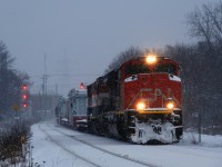 CN 527 has a pair of D3 dimensionals up front as it passes MP 3.13 of CN's Montreal Sub during a snowstorm. Power is CN 8021 & BCOL 4609.