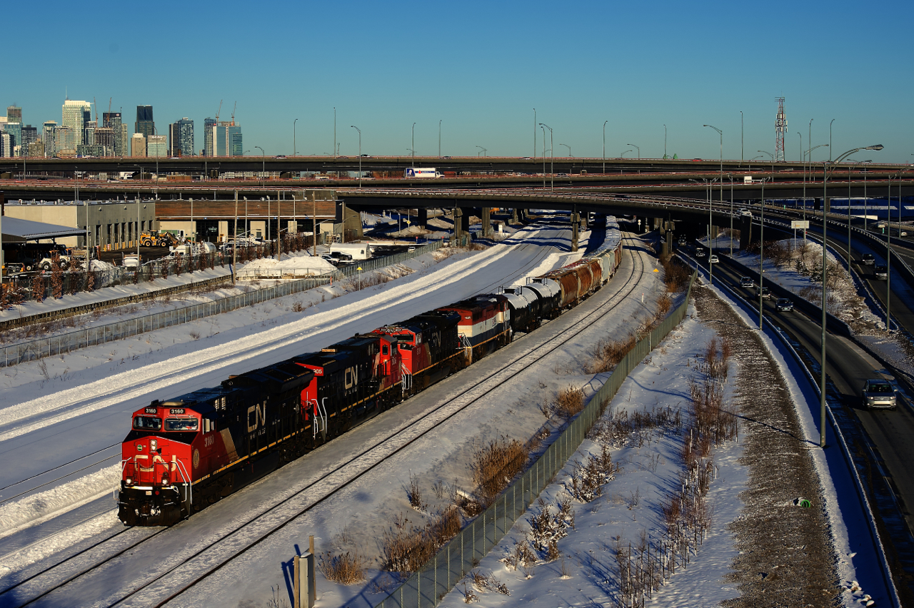 CN 527 has two AC units off of CN 322 leading and CN 8021 and BCOL 4609 trailing as it heads towards Taschereau Yard after working Pointe St-Charles Yard. The last unit is the last active cowl on CN and it would be put into the shops that afternoon with numerous issues.