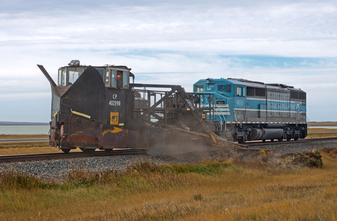 SD40-2F CMQ 9010 and Jordan Spreader CP 402998 are in the process of cutting away some soil and ballast on the north side of the main between Morse and Herbert SK on the Swift Current Sub. Perhaps prepping for winter and the subsequent spring runoff? I wont pretend to know.