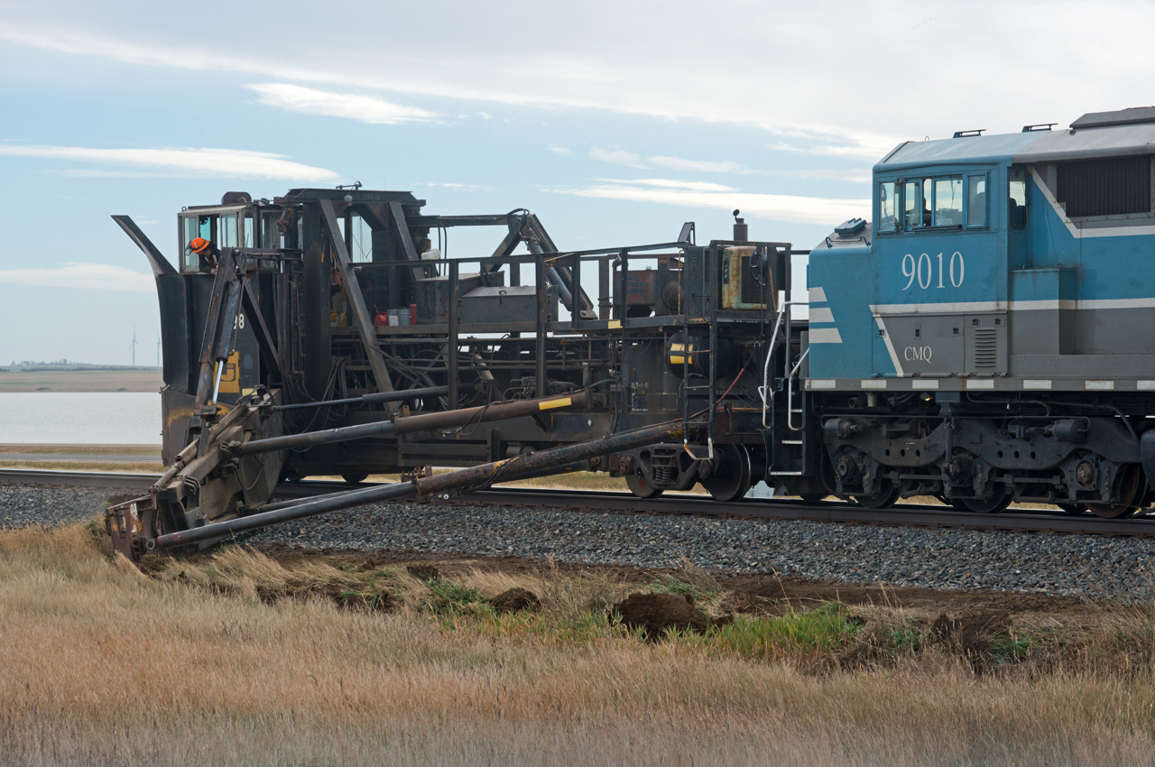SD40-2F CMQ 9010 and Jordan Spreader CP 402998 are in the process of cutting away some soil and ballast on the north side of the main between Morse and Herbert SK on the Swift Current Sub.  Perhaps prepping for winter and the subsequent spring runoff? I wont pretend to know.