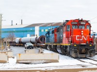 The CN 0700 Yard Job with a dimensional load from Hooper in the Eastport area. These moves happen only a couple of times a year as far as I know, and are typically handled under darkness by the 1600 Yard Job. Aside from empties going in on the 1600, this is the first pull from Hooper I've ever seen. At the time of the photo, the load was stuck against the fence of the adjacent scrap yard.