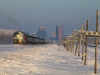 CMQ 9011 West concludes my winter break of railfanning, leading CP E44-06 past Mile 97 Indian Head. The Regina Skyline hides under shadows behind the short Moose Jaw-bound local.