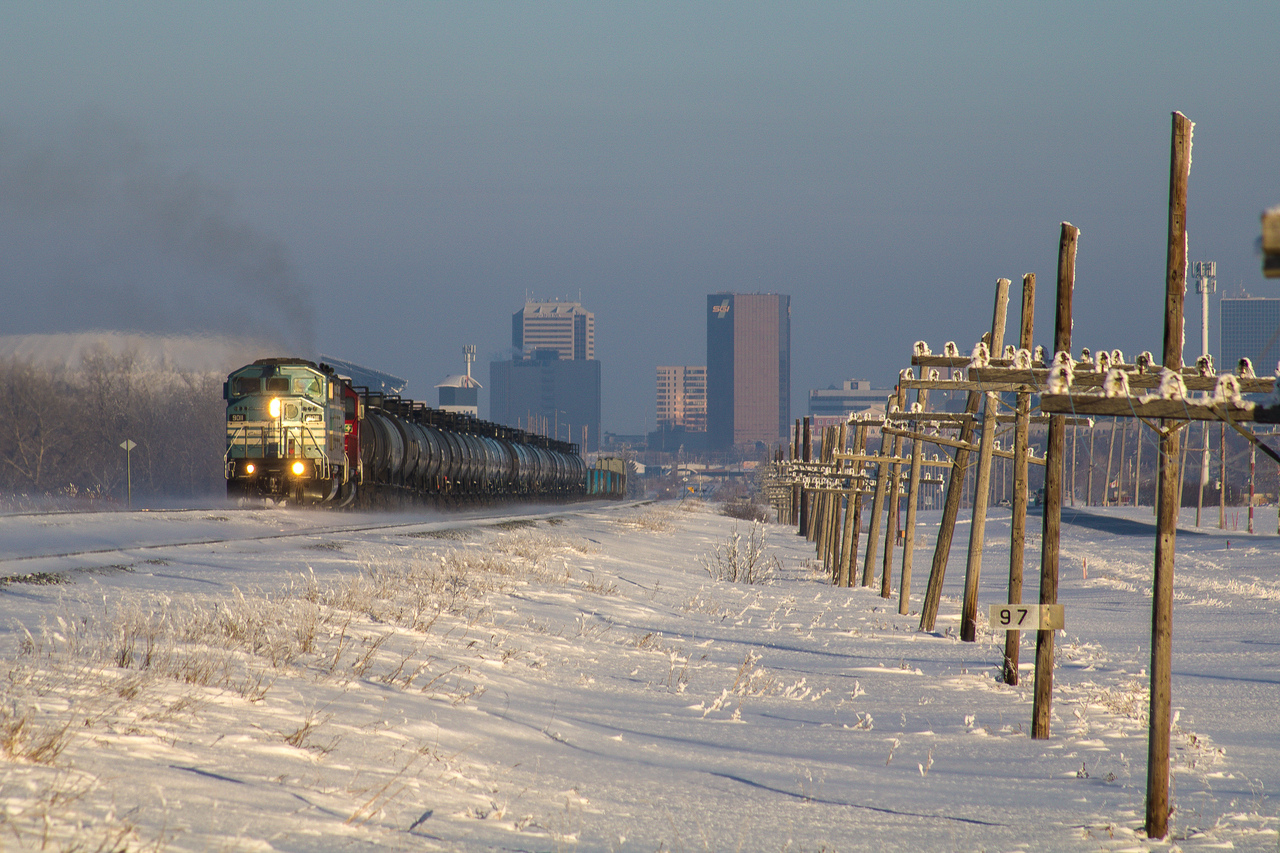 CMQ 9011 West concludes my winter break of railfanning, leading CP E44-06 past Mile 97 Indian Head. The Regina Skyline hides under shadows behind the short Moose Jaw-bound local.