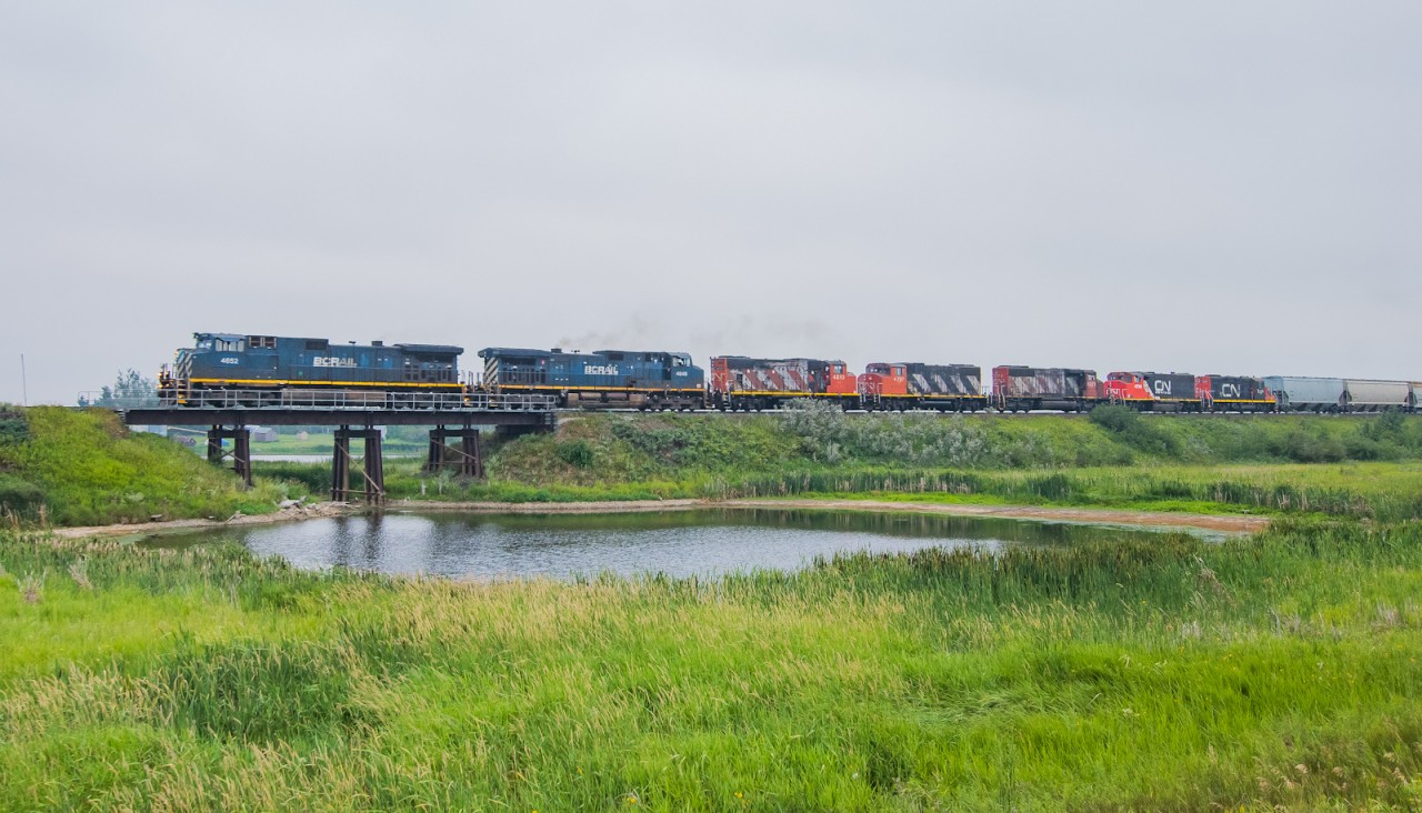 An interesting set of power originating from Saskatoon makes its way east towards Melville approaching the beginning of double track at Fenwood.