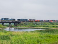 An interesting set of power originating from Saskatoon makes its way east towards Melville approaching the beginning of double track at Fenwood. 