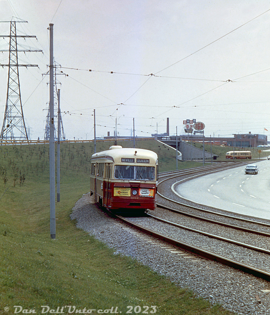 TTC PCC 4012 (A1-class, built CC&F 1938) heads eastbound on the new Queensway streetcar PRW (private right-of-way, opened the previous year in July 1957), having departed nearby Humber Loop and ducking under the eastbound Queensway underpass in the distance to begin its trip east along Queen to Neville Loop in the Beaches neighbourhood. A TTC Can-Car transit bus can be seen leaving the loop in the background, near the old Oshawa Foods (IGA, Towers, etc) distribution warehouse.

Original photographer unknown (duplicate slide), Dan Dell'Unto collection slide.