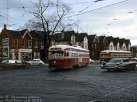 Operating on westbound Harbord run on a gloomy winter's day, TTC PCC 4303 (A6-class, built CC&F 1947) makes the turn from northbound Spadina Avenue to westbound Harbord Street. Sister car 4324 follows behind (seen later <a href=http://www.railpictures.ca/?attachment_id=31128><b>here</b></a> detouring back eastbound via Bloor and down Spadina). The row of Victoria-era houses in the background would be gobbled up by the nearby University of Toronto's expanding St. George campus in the following years (no doubt "Varsity Food" is due to UofT's nearby proximity).<br><br>The Harbord streetcar route would be discontinued a year later, its last day of service February 25th 1966, coinciding with the opening of the new crosstown Bloor-Danforth subway line the next day.<br><br><i>John F. Bromley photo, Dan Dell'Unto collection slide.</i>