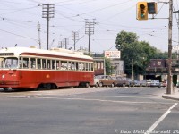 TTC PCC 4756 (A14-class, secondhand from Kansas City MO) is paused at the light before making the right turn onto Weston Road for the short jaunt up to <a href=http://www.railpictures.ca/?attachment_id=34071
><b>Keele Loop</b></a>. Either the streetcar is broken down or the operator has hopped off to attend to something, but it has caused traffic to back up coming out of the railway underpass (CN Weston Sub & CP MacTier Sub) and motorists are diverting into the right lane to get by.
<br><br>
On top of the underpass are a few freight cars (including a green-door double-door CN or DW&P lumber service boxcar), probably overflow from the nearby CN West Toronto yards. Webster & Sons Ltd Building Materials had a siding just to the north, one of many small industries in The Junction area to receive rail service.
<br><br>
TTC 4756, originally built as Kansas City 749 by St. Louis Car Co. in 1946 and acquired secondhand by Toronto in late 1957, was retired by the TTC in 1976 and was part of a group of PCC's sold to SEPTA in Philadelphia as their 2242. They were purchased to replace some of the cars SEPTA had recently lost in a carhouse fire, but were in poor shape and only lasted a few years in service for their third owner.
<br><br>
<i>Original photographer unknown (possibly a C.G. Parsons original), Dan Dell'Unto collection slide.</i>