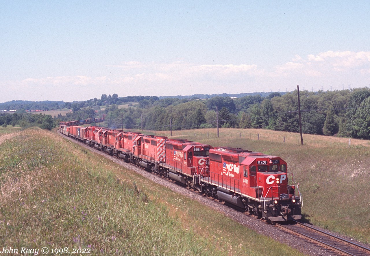 Summer 1998, CP SD40-2s 5421 and 5616 with five siblings at Nichols Rd, MP 150.5 CP Belleville sub with an eastbound container train.