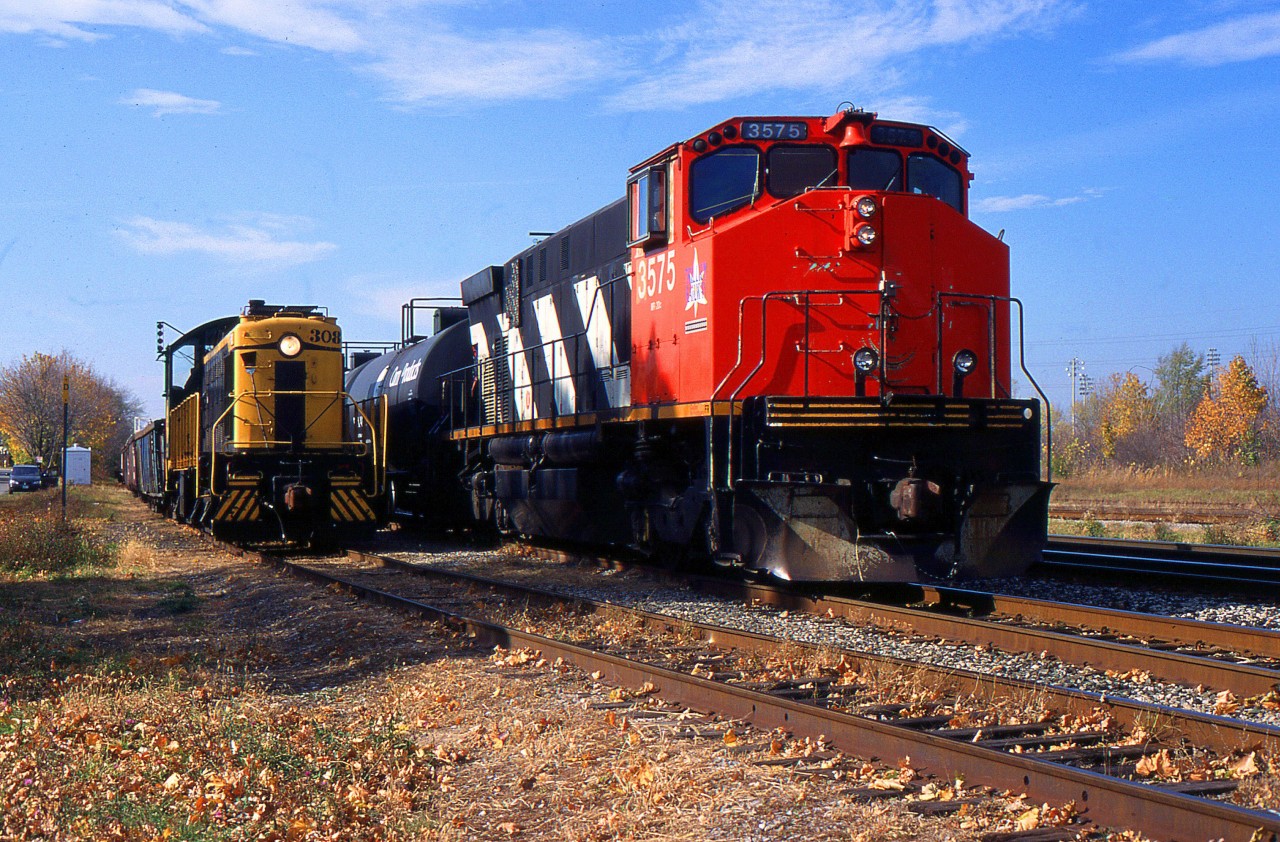 During the Fall of 1999 when Trillium Railway did their Interchange at Merritton TRRY 3575 lifts their cars and get ready to head southbound up the Thorold Spur, as PCHR 308 waited for them to clear so they can head back over the north side.
