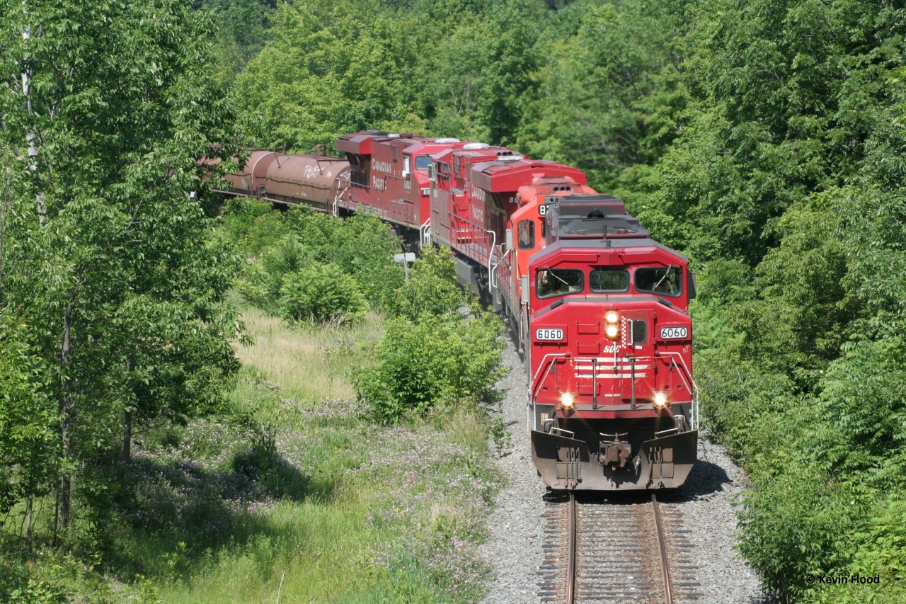 On a gorgeous summer afternoon, a southbound CP train on the Hamilton Sub descends towards Hamilton with SOO 6060 leading a GP9 and two GEs.
