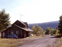 West of Edmonton, Canadian Northern and Grand Trunk Pacific both built rail lines to the Yellowhead Pass, and west of Hinton, CNor was on the north side of the Athabaska River with GTP on the south.  This is a view eastward at the former CNor depot at Entrance, now known as Old Entrance, with the name relocated across the river to the GTP station originally called Dyke, where CN runs today.  The depot still stands, serving as the office of Old Entrance B ‘n B Cabins and Trail Rides.

<p>At the time of the photo, the gravel road shown continued to the west behind the photographer to the CN bridge at mile 193.6 Edson sub. near where the GTP alignment was connected to the CNor, but recent aerial views suggest that is probably impassable now.