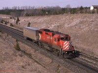   CP 3043 leads a very small No 528, consisting of just the Triple Crown adapter car passing through Coakley on the Galt Sub March 31st 1992. Not sure why the lack of traffic, suspect the connecting train at NS Oakwood Yard (Detroit) was late and they would require the power and adapter for the Westbound train out of Lambton that afternoon.  