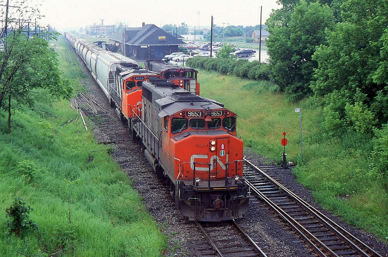 A busy afternoon out at St. Catharines on a rainy afternoon as 449 with CN 9653 passed the work on the south track and the work train with CN 3572 on the north track picked up a section of rail as they started to limit the turnouts for the sidings during 1997.