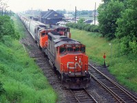 A busy afternoon out at St. Catharines on a rainy afternoon as 449 with CN 9653 passed the work on the south track and the work train with CN 3572 on the north track picked up a section of rail as they started to limit the turnouts for the sidings during 1997.
