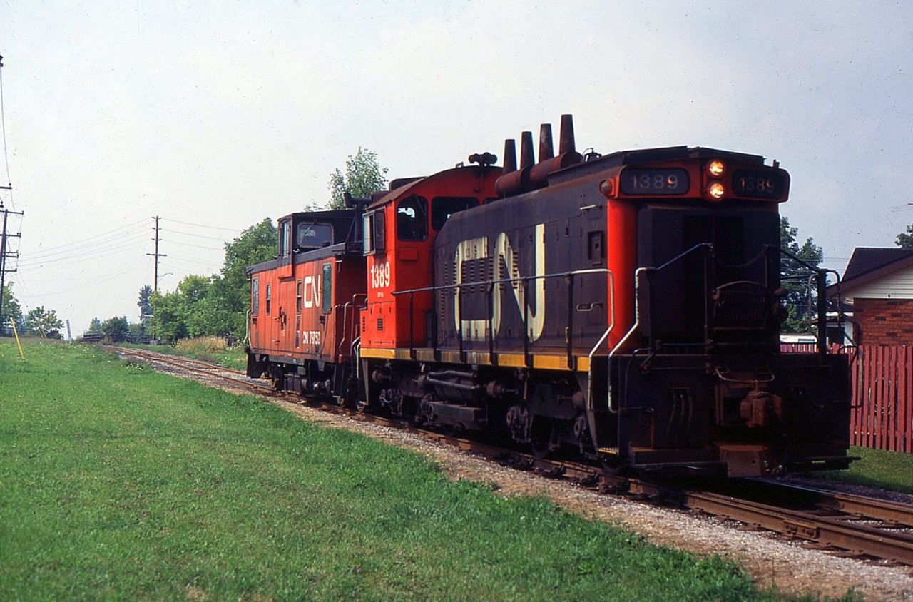 549 with CN SW1200RS 1389 and CN Van heading northbound on the CN Fonthill Spur just crossed over Hwy 58 in the background.