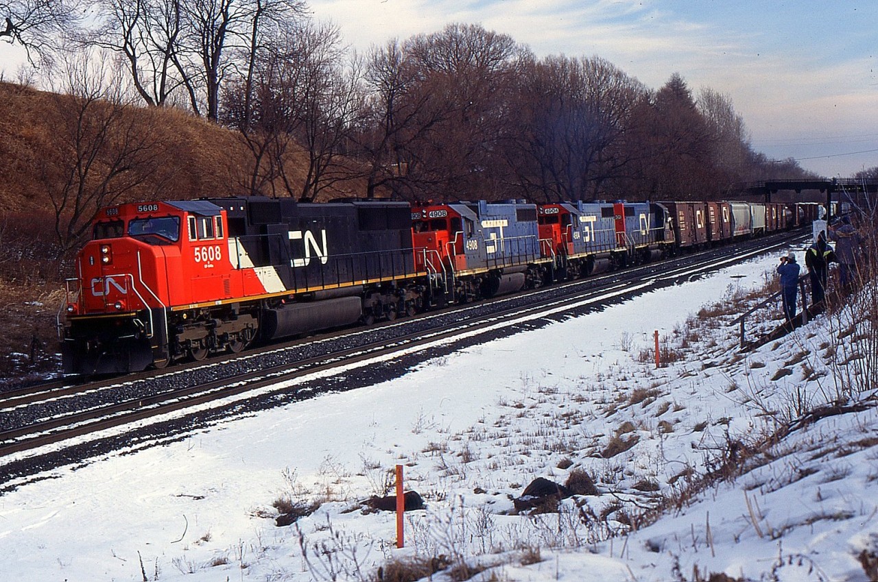 A CN Westbound with CN SD70I 5608, GTW GP38-2 4908, GTW GP38-2 4904, and CV GP38-2 5801 climb the grade up at Copetown at Inksetter Rd.