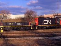 CN GP9RM 7246 and CN Slug 264 at Niagara Falls Yard in 1998. The yard tracks have been all removed and it's an empty field.