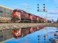 With the typical presence of meltwater after a recent snowfall in Toronto, I spotted a well-placed puddle west of the Howland signals. Using the digital viewfinder on my DSLR to keep the camera at ground level, I only had enough time to grab one shot of the fast-coming 421. Being a partly cloudy day with some shadows just metres away, I was lucky to get full sun and a relatively tolerable leader to boot.