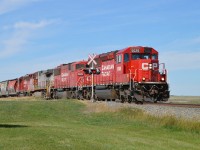 We were heading over to shoot pics of the restored and relocated CP SweetGrass station when we came across this CP train slowly making its way to the US border after being held up by a redboard.
CP 5026, 6258, BNSF 685 and CP 5033 provide the power.  Nice to see an SD60M as well as a BNSF "Bonnet" in the same train consist. And a nice day as well. As you can see on the right; there is some rather flat lands in Southern Alberta.  Train is crossing Hwy 846, and I had to scramble for this shot. Getting too old for this s**t.