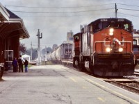 This was an early on slide for me, and still one of my favourites. This was my first visit to Kitchener station, and at the time I knew all the 251 powered Alco/MLW’s were on borrowed time. All the six axle vets were already gone but the slightly newer Bombardier built HR616 would last a few years longer than the other six axle non cowl versions. High reliability was certainly not something these units lived up to and spent almost as much time out of service, as they did in service. While the motive power this day definitely caught my eye, so did the kids taking in the action that definitely helped make the photo. Over the years I have spent a lot of time at the old station, day and night. Fond memories for sure. Here train 432 prepares to stop and work the yard, with a crew member dead heading in the trailing M420, and a long cut of salt hoppers out of Goderich trailing the power and flat cars. 