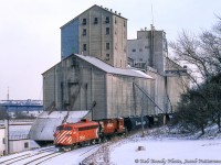 <b>"It'll cut through snow as high as the headlight!"</b>  The CP Goderich wayfreight, ordered at Hamilton Chatham Street, generally saw various models of GMD and MLW road switchers assigned as power over the years, but during the harsh winter months an F-unit often made an appearance.  Longtime wayfeight engineer Donald Broadbear regularly requested this power to cut through the heavy lake effect snowdrifts of Perth and Huron Counties.  Here, the wayfreight switches cars at the Goderich Elevators before returning home to Hamilton.  Note the Maitland River trestle in the distance, which the train will cross upon departing the yard.<br><br>Well known in railway circles for his knowledge of steam locomotives, Don Broadbear passed away earlier this week on February 21, 2023, weeks after his 92nd birthday.  He and his father, Percy, owned the Pinafore Park Railway in St. Thomas where many got their start in railway preservation.  Don was also a founder of the Port Stanley Terminal Railway, the Ontario Southland Railway, took on the task of restoring and operating Essex Terminal 0-6-0 number 9 as part of the Southern Ontario Locomotive Restoration Society (SOLRS/St. Thomas Central Railway), and later at the Waterloo Central Railway.  <br><br>Don's obituary <a href=https://www.arbormemorial.ca/forestlawn/obituaries/donald-broadbear/99868?fbclid=IwAR3-p5giyTU00P_pDqzvFNbj2uO6No36sHeWVnDOkX5OyfRgfWs5vZHUyWA>can be found here.</a><br><br><i>Rob Bondy Photo, Jacob Patterson Collection.</i>