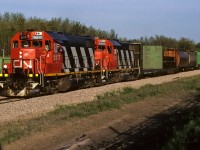 A short Muskeg Mixed makes it easy to frame fit. :^) The units are fresh and crispy tonight. Looking into my notes, the 5517 I first spotted in stripes Sept.86 and the 5503 with hers in March 87. Lucky chance to have them both headed in the same direction. That is Baggage 7856, Coach 5095 and Caboose 79881 at the rear. It is just a short distance to the connecting track where the Lac La Biche Sub. will take the mixed train north.