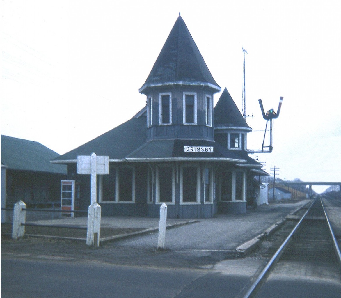 Yes; this early April day back in 1974 was as gloomy this scene appears. But I rather like the mood of it.
The image is of the Grimsby CN station, looking west. The structure burned own on the last day of 1994, after several years serving commercial purposes. Electrical fire.  The building on the extreme left is the GWR (Great Western) station, built 1855; and has been thru several changes over the many years of its existence.  Currently, it stands vacant. Renovated inside and out, it was to become an eatery/pool hall but financial difficulties have put the project on hold this last 3 years.