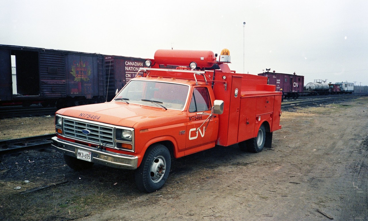 During my tenure as CN's Regional Supervisor Work Equipment Operations in the mid-1980's, I was able to renew the fleet of Work Equipment Field Maintainer vehicles with new, purpose-built service trucks. CN N175464, a 1985 Ford F-350 XLT had only been in service a few short months when I snapped this photo. These well equipped (at the time) vehicles had an air compressor, diesel fired welding machine, oxy-acetylene equipment, tool chest storage compartment, component bins and racks, and plenty of space for spare and repair parts. They certainly stood out amongst the crowd in their bright CN Orange No. 12 Work Equipment paint. Behind the truck is a plethora of vintage CN rolling stock from the era. 40' box cars in Work Equipment tool car service, a wood sheathed box car converted to a generator car, a Work Equipment machinery flat, an insulated and heated water transport tank car, a transfer van, and a Transportation Department 'Blue Fleet' accommodation unit. Oh, the good old days! :-)