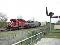 This is one of those places where I felt a bit of a different scene might help an image of the afternoon train heading west into Hamilton.  This is #255, and the time is around 1400 hrs.  I am on the porch of the old Smithville TH&B station. An alternative to shooting fields and trees. :o)
CP 5919, ICE 6215 and CITX 3055 is moving along smartly with a colourful consist typical of those days.  The last time I saw the CP 5919, it was working on Big Sky Rail out in Saskatchewan, having been acquired in 2020 from CP.