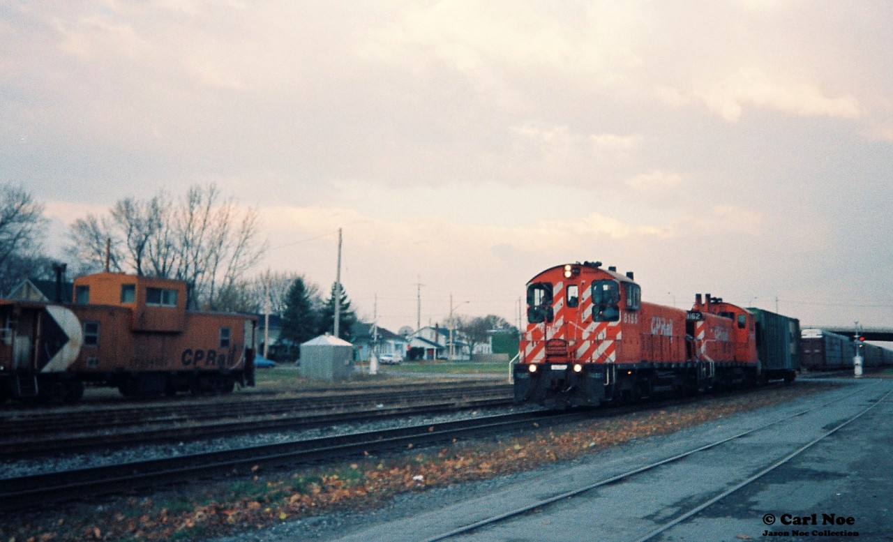 The Afternoon CP Galt Job with 8155 and 8162 are out on the Galt Subdivision mainline going west with one BN hopper as they head to Ayr to work the Ayr Pit Spur during an overcast late fall day.