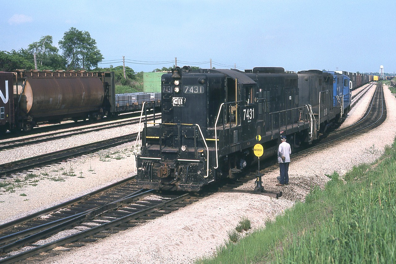 In what was a daily occurrence back then, the CR transfer has just come over from Buffalo and dropped traffic at the west end of the Fort Erie yard. It will then run east after switching to an open track and pick up traffic bound for the USA.
I liked to catch this job before the power was painted into Conrail colours. CR 7431, 3813 and 6820 is the consist on this day. Note the middle loco is a "B" unit (no cab). There were about 20 or so of these GP9B units, but I had rather miserable luck in catching many of them.