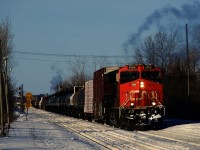It's a bone-chilling morning (windchill of about -40 Celsius) as CN 372 slowly approaches Dorval Station after holding west of here for a bit. Exhaust is visible from both the leader and the DP, which is only about 15 cars from the head end.