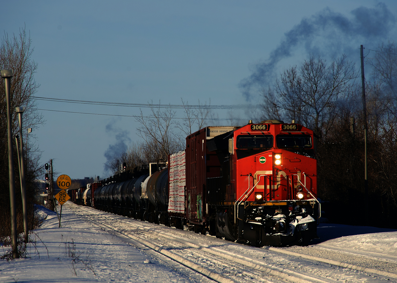 It's a bone-chilling morning (windchill of about -40 Celsius) as CN 372 slowly approaches Dorval Station after holding west of here for a bit. Exhaust is visible from both the leader and the DP, which is only about 15 cars from the head end.