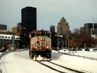CN 9523 has an incredibly faded nose as it leads a short train of baretables out of the Port of Montreal.