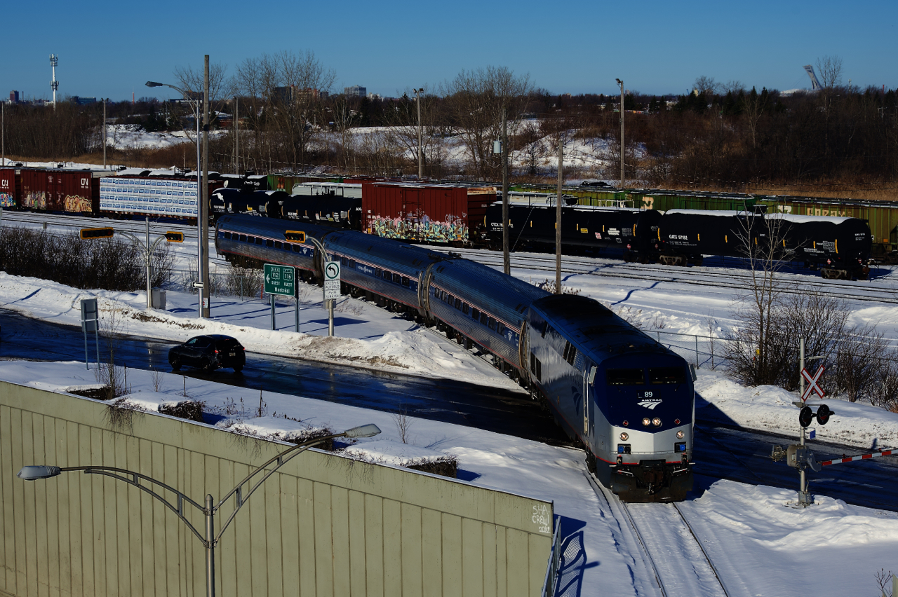 An Amtrak requalification run has just left the CN St-Hyacinthe Sub and is now on the CN Rouses Point Sub, with clean AMTK 89 for power. Behind, CN 522 is shuffling cars at Southwark Yard.