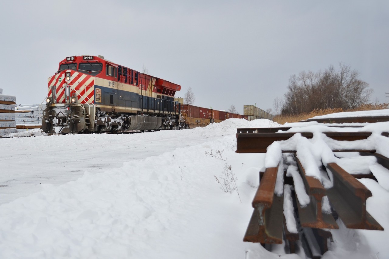 The fresh smell of lumber is in the air as CN 3115, adorned in the striking BC Rail "Hockey Stick" livery, glides south through the timber yards of Vandorf, ON. CN 3069 and 3008 led consecutive northbounds not even a week prior, giving local railfans a heritage hat trick of sorts.