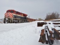 The fresh smell of lumber is in the air as CN 3115, adorned in the striking BC Rail "Hockey Stick" livery, glides south through the timber yards of Vandorf, ON. CN 3069 and 3008 led consecutive northbounds not even a week prior, giving local railfans a heritage hat trick of sorts. 